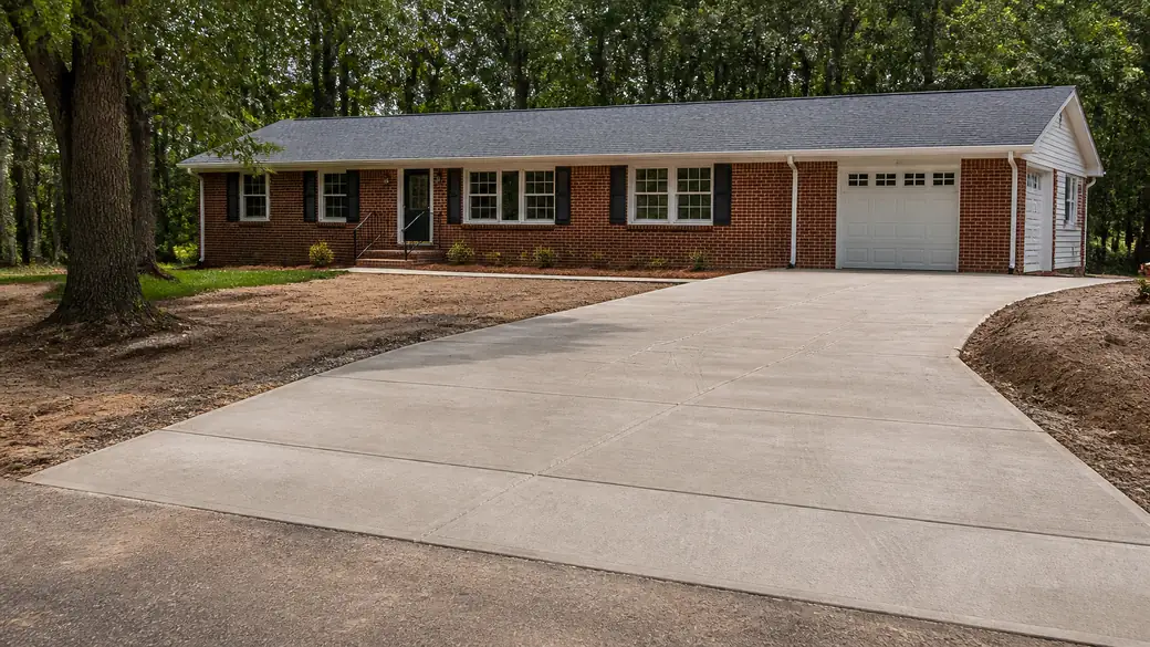 cement installation completed by a local contractor at a tan-brick colonial in Bowling Green, KY, at blue hour.